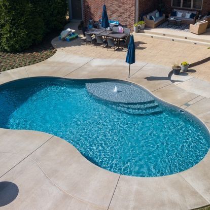 An aerial view of a large swimming pool in a backyard