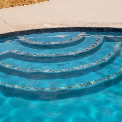 A close up of a swimming pool with stairs in it.