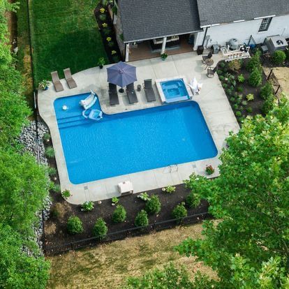 An aerial view of a large swimming pool in a backyard