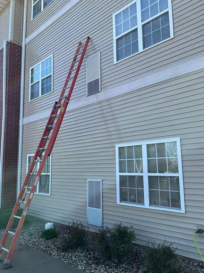 A ladder is leaning against the side of a building.