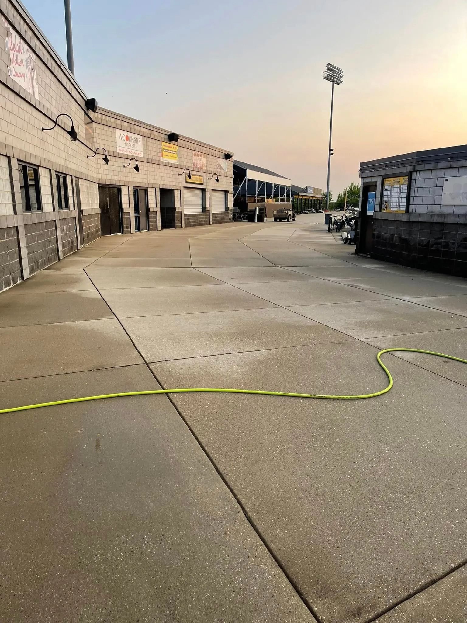 A hose is laying on the ground in front of a building.