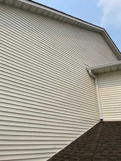 A house with white siding and a brown roof.