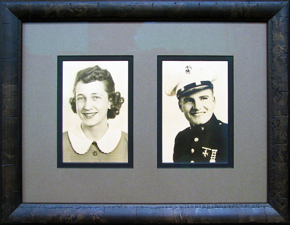 A black and white photo of a woman and a man in uniform