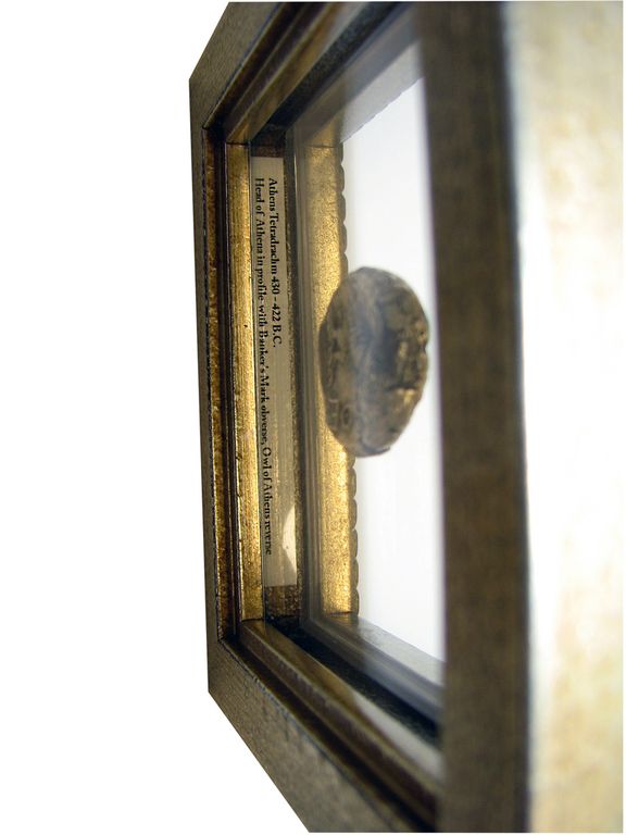 Greek coin in double sided frame