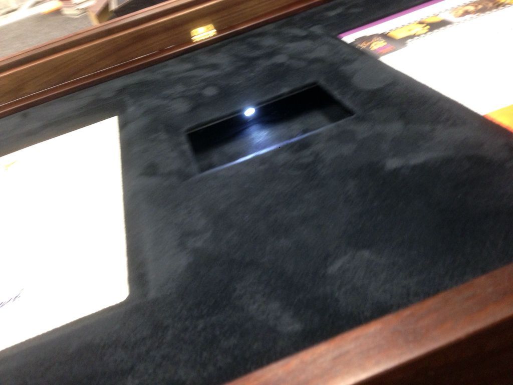 Award with belt buckle in front opening shadow box frame with illuminated opening