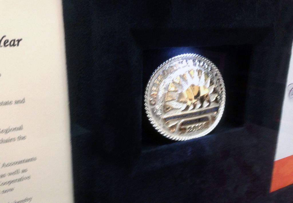 Award with belt buckle in front opening shadow box frame with illuminated opening detail