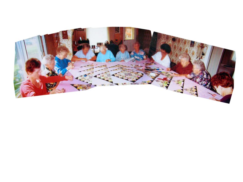 A group of people are sitting around a table playing a game