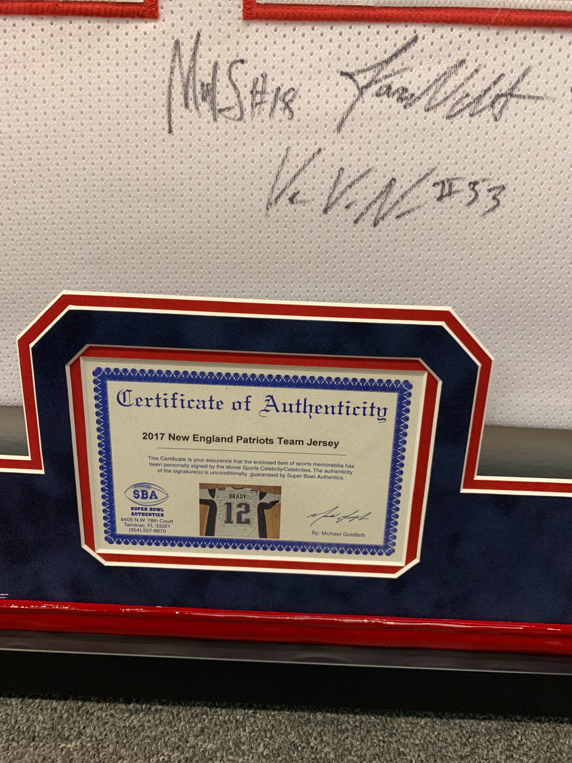 A framed jersey with a certificate of authenticity