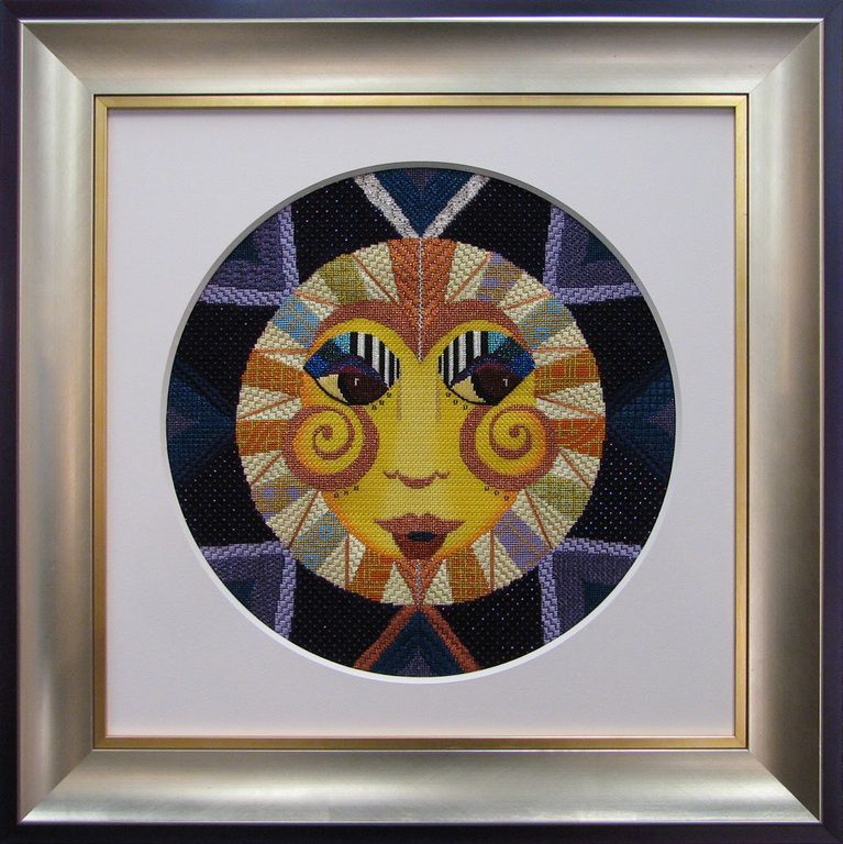A framed painting of a face in a circle