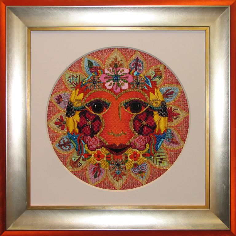 A framed picture of a face with flowers on it