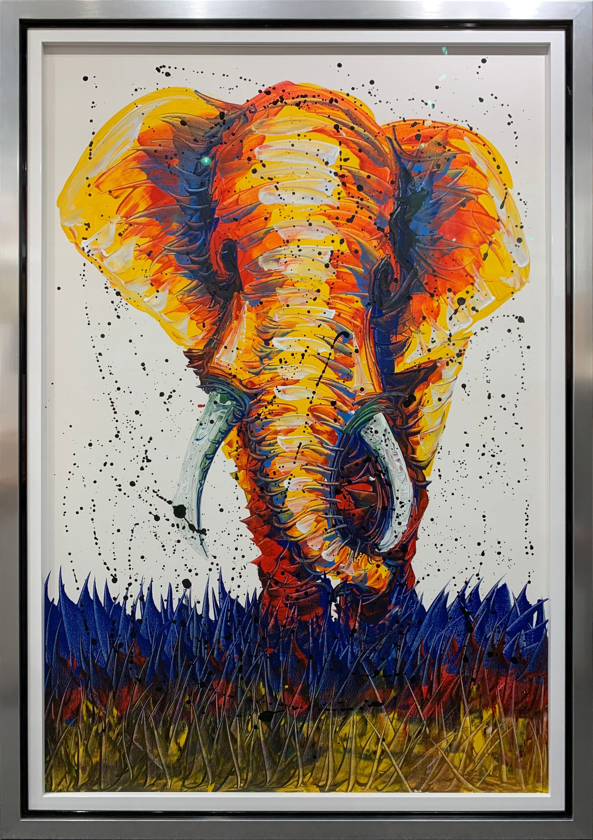 A colorful painting of an elephant in a silver frame