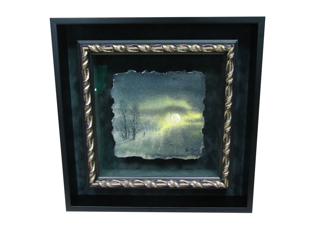 A picture of a full moon in a black frame