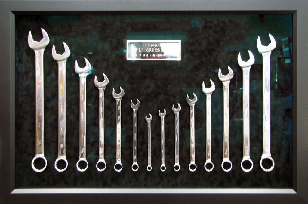 A bunch of wrenches are lined up in a row