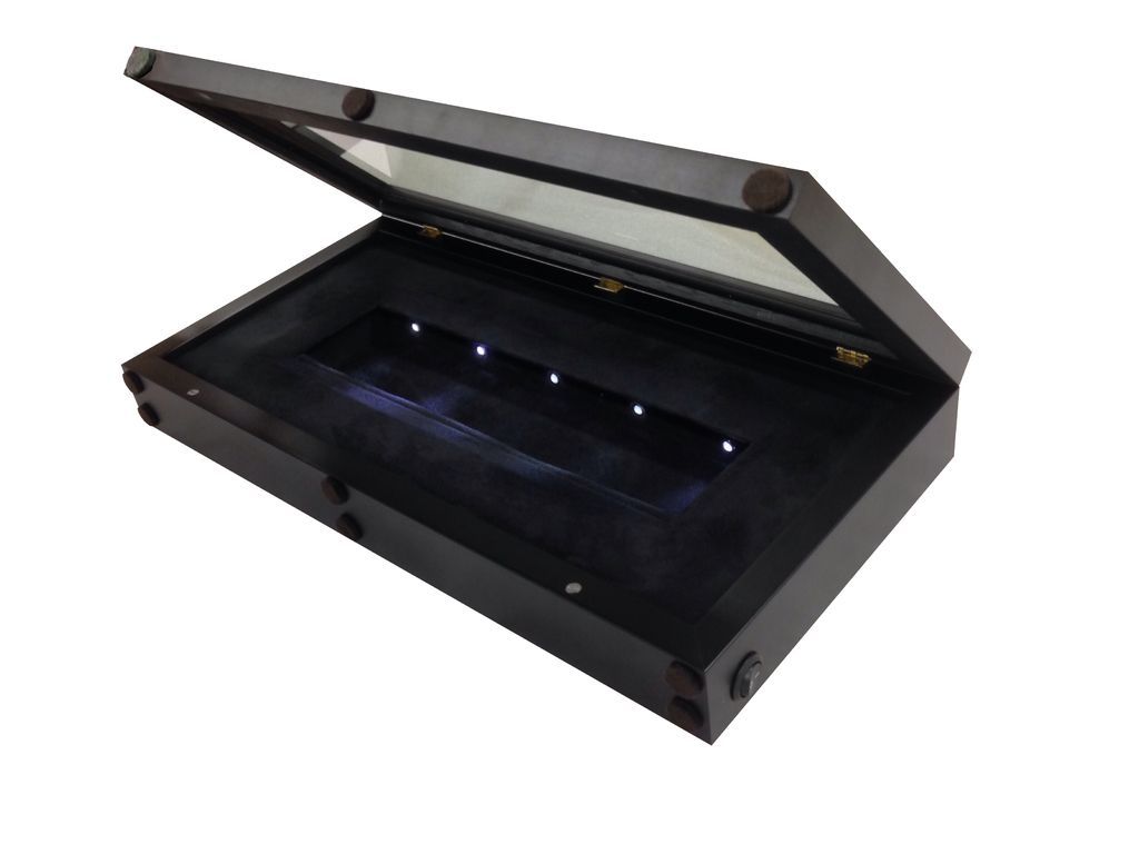 A wooden box with a glass lid and lights inside