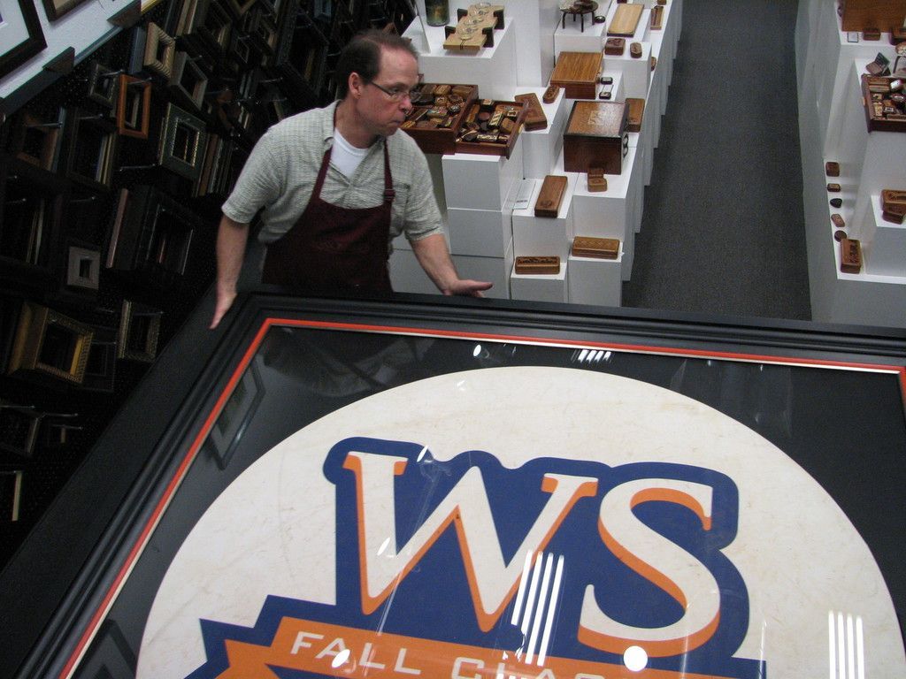 A man stands in front of a sign that says WS