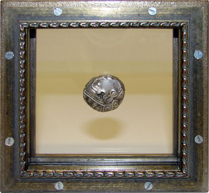 A frame with a coin inside of it