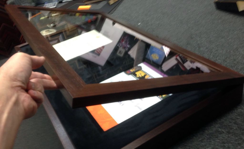 A person is holding a picture frame in their hand