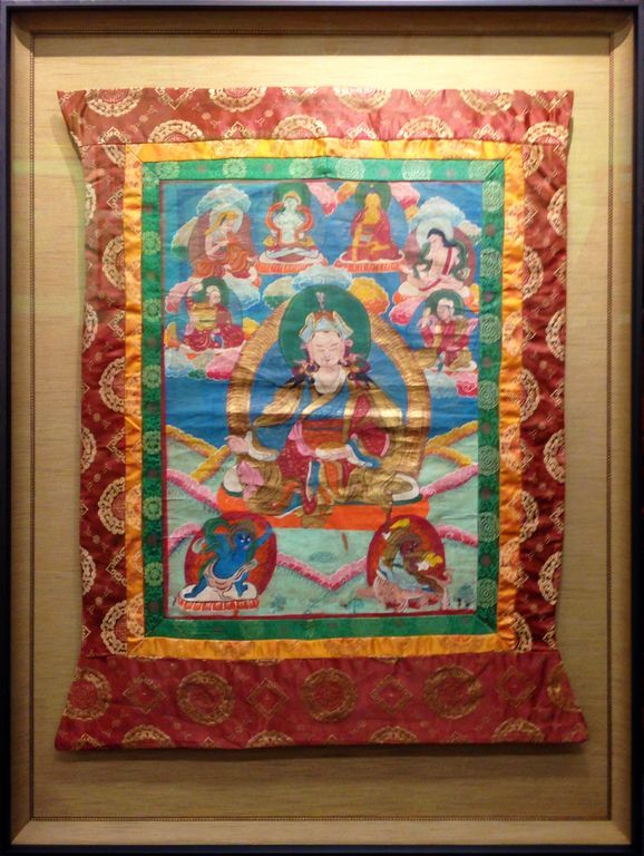 A framed painting of a woman surrounded by angels