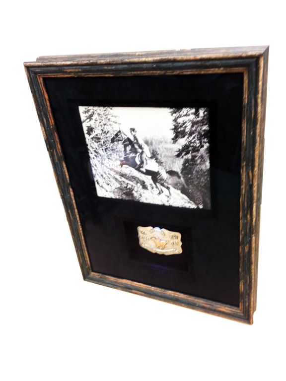 A framed picture of a man climbing a mountain