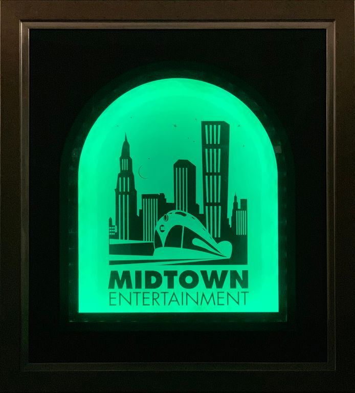 A glow in the dark sign for Midtown Entertainment