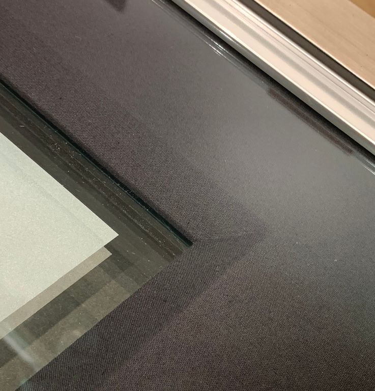 A close up of a window with a white trim