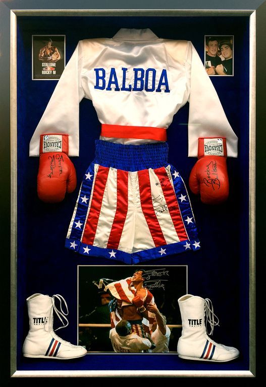Balboa boxing gloves and shorts are displayed in a frame
