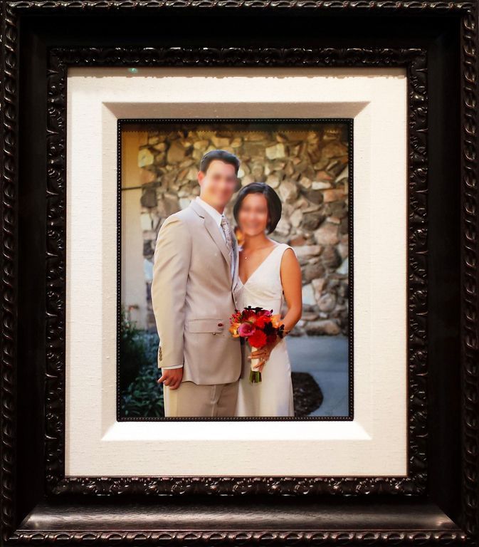 A picture of a bride and groom in a frame