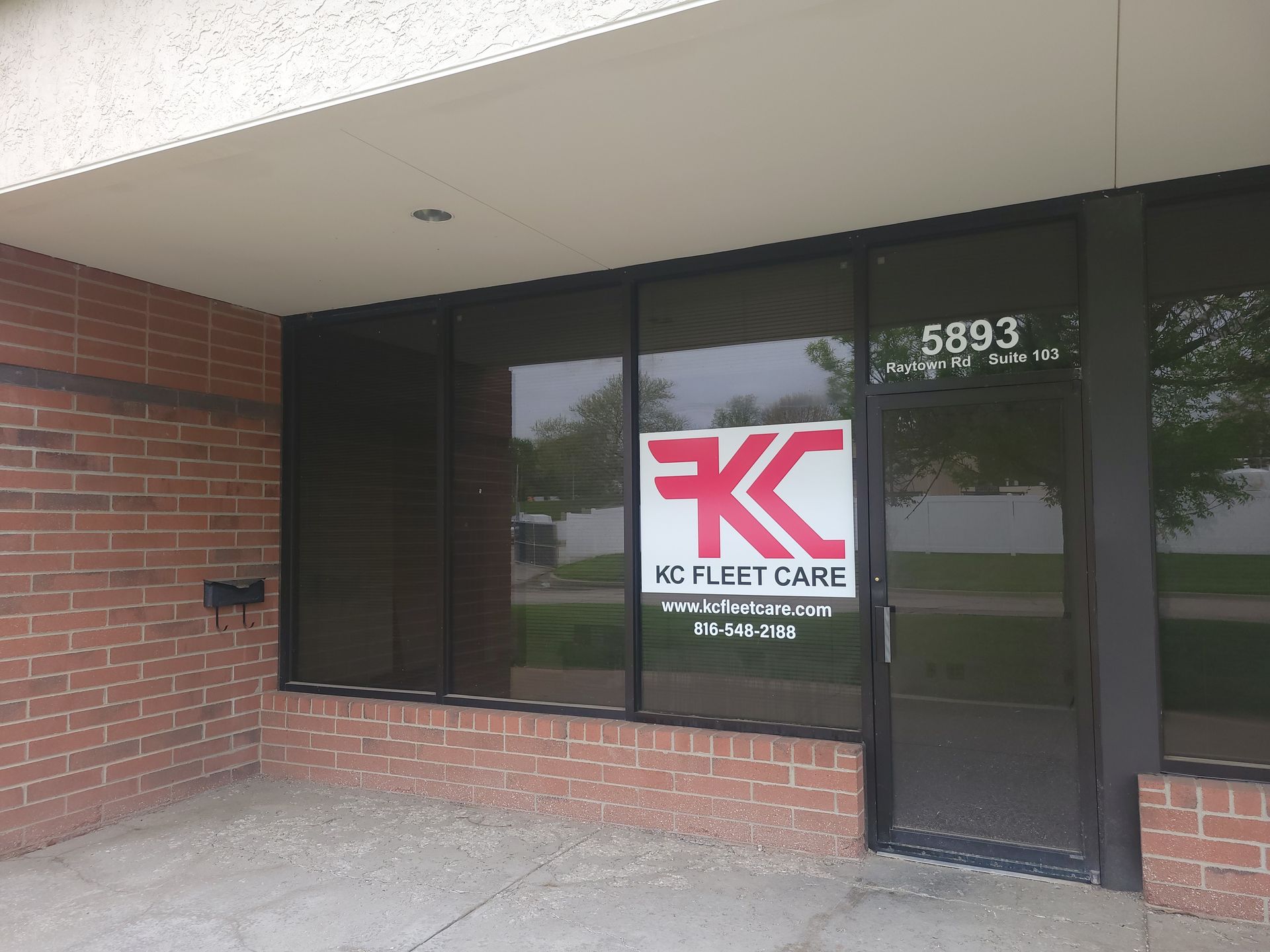 A white semi truck is parked on the side of the road.