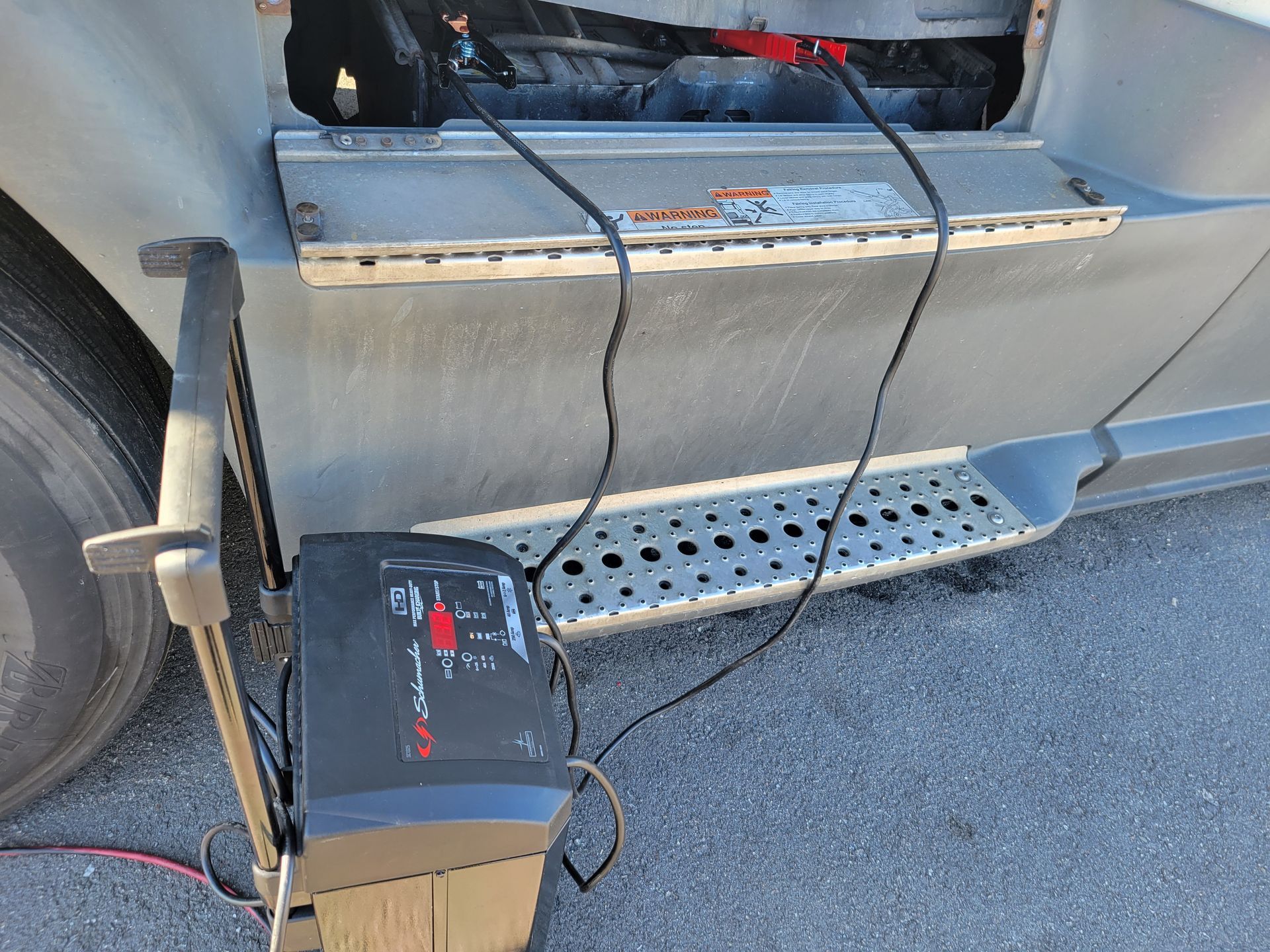 A truck is being charged with a battery charger.