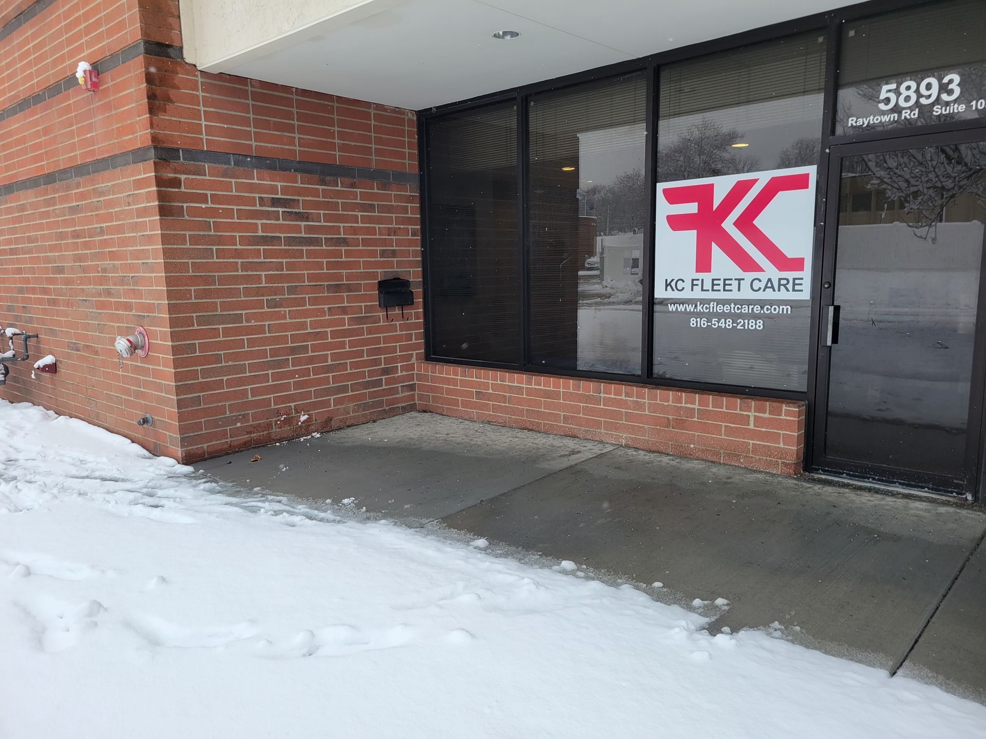 A brick building with a sign that says kk on it
