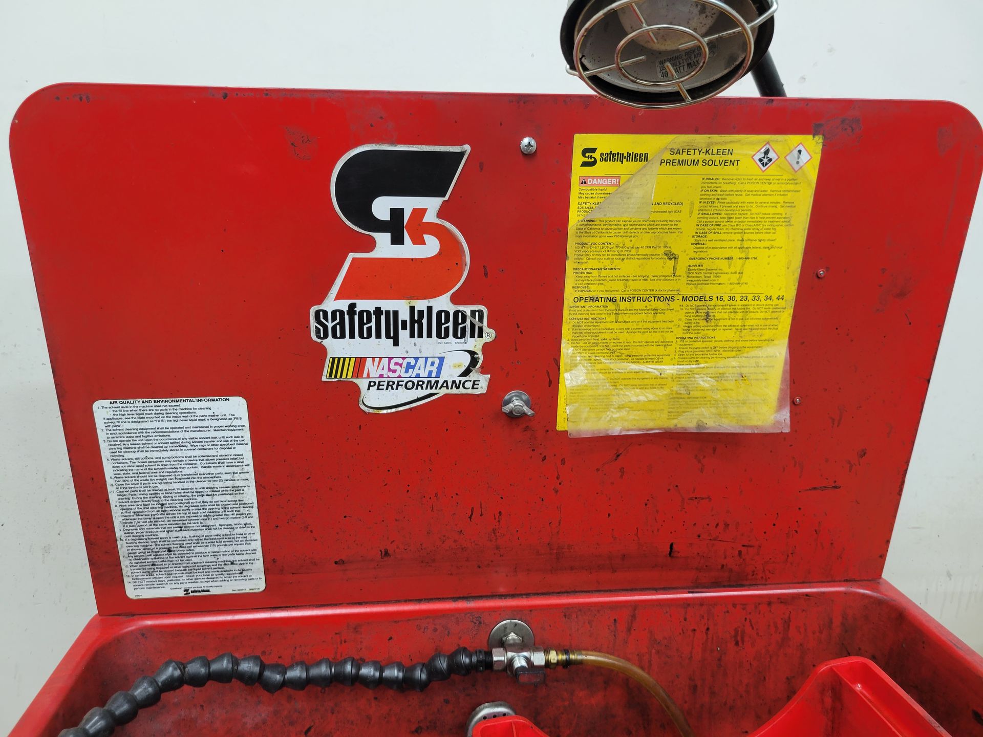 A red box with a sticker on it that says safety-kleen