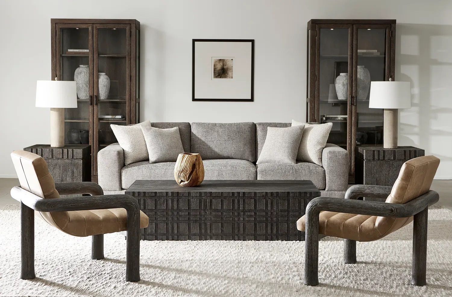 A living room with a couch, two chairs and a coffee table.