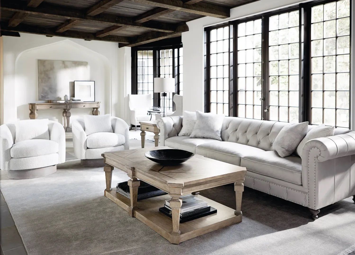 A living room with white furniture and a coffee table