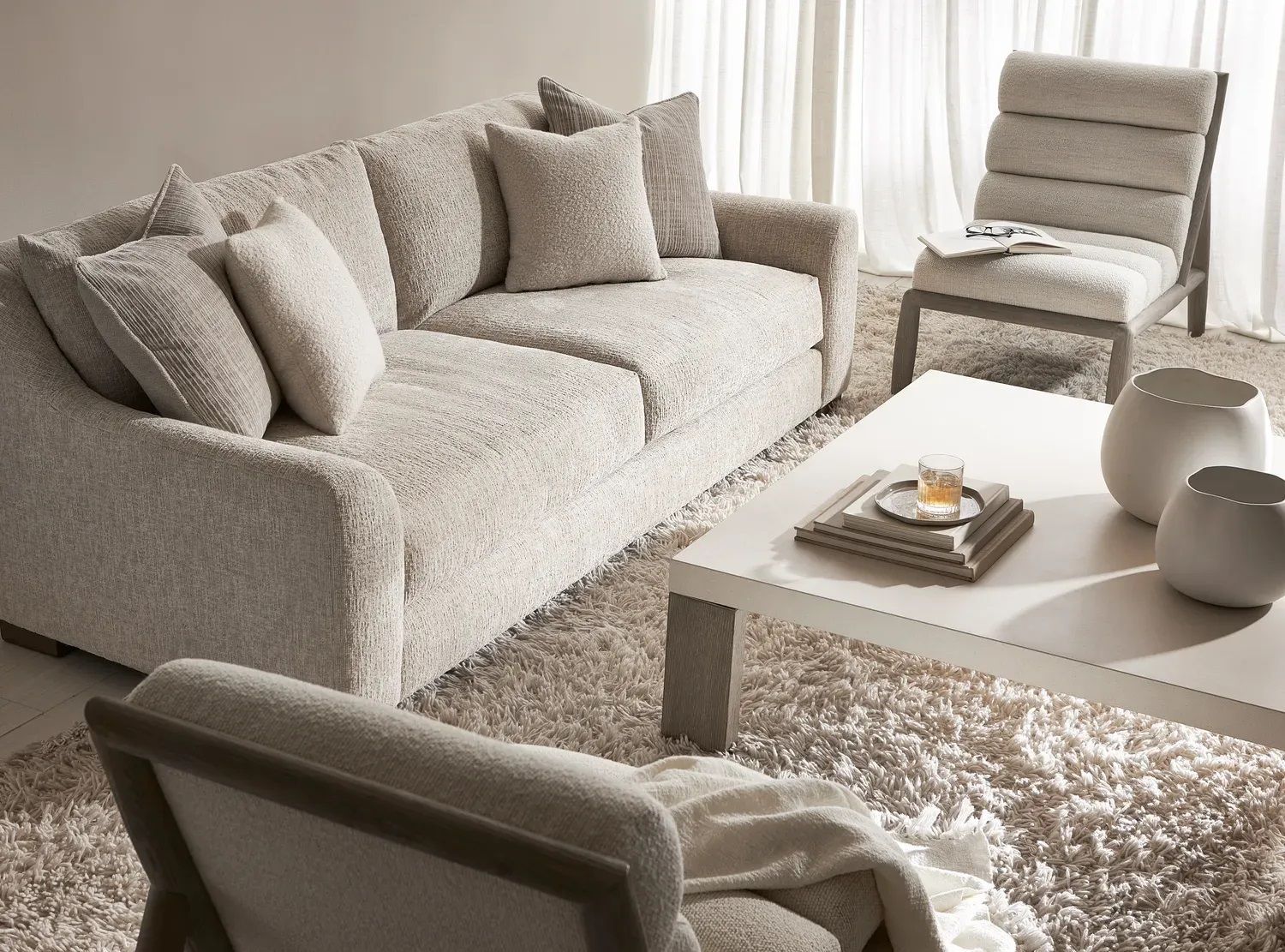 A living room with a couch a chair and a coffee table