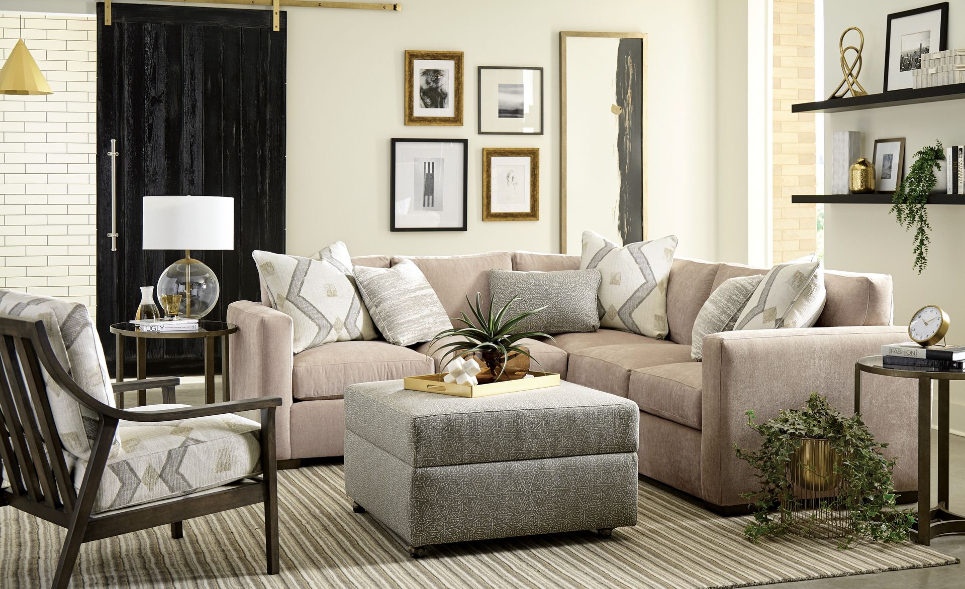 A living room with a sectional couch , chairs , ottoman and rug.