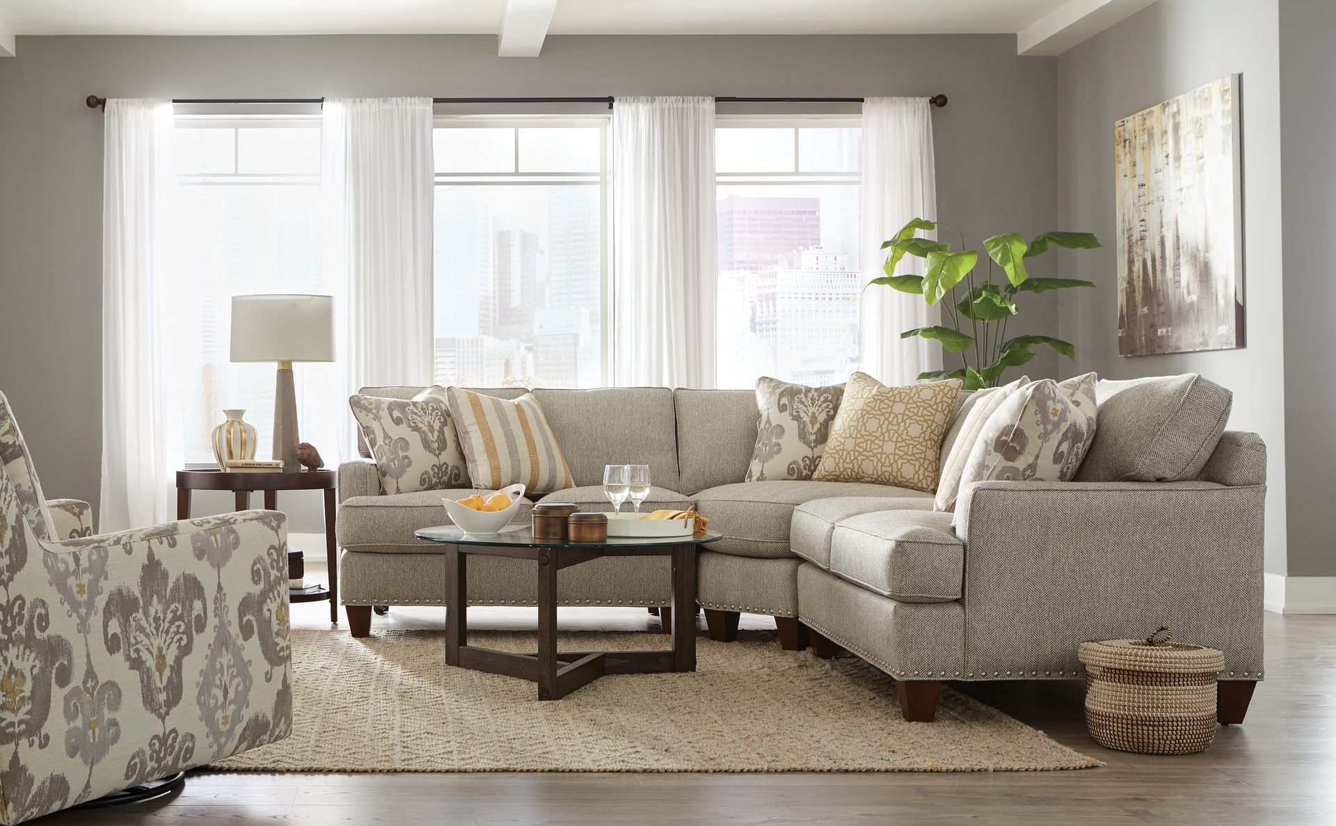 A living room with a sectional couch , chair , and coffee table.