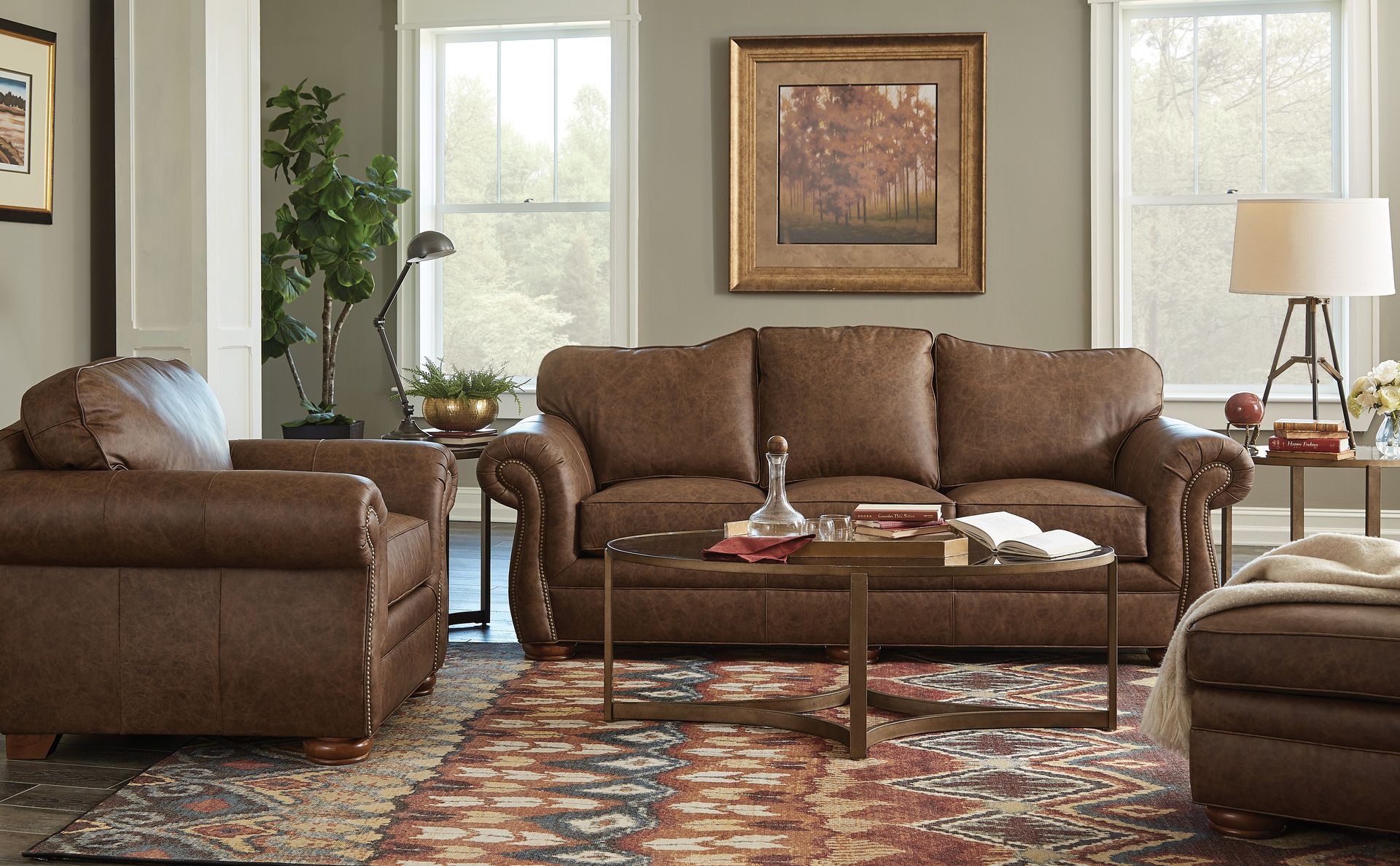 A living room with a couch , chair and ottoman