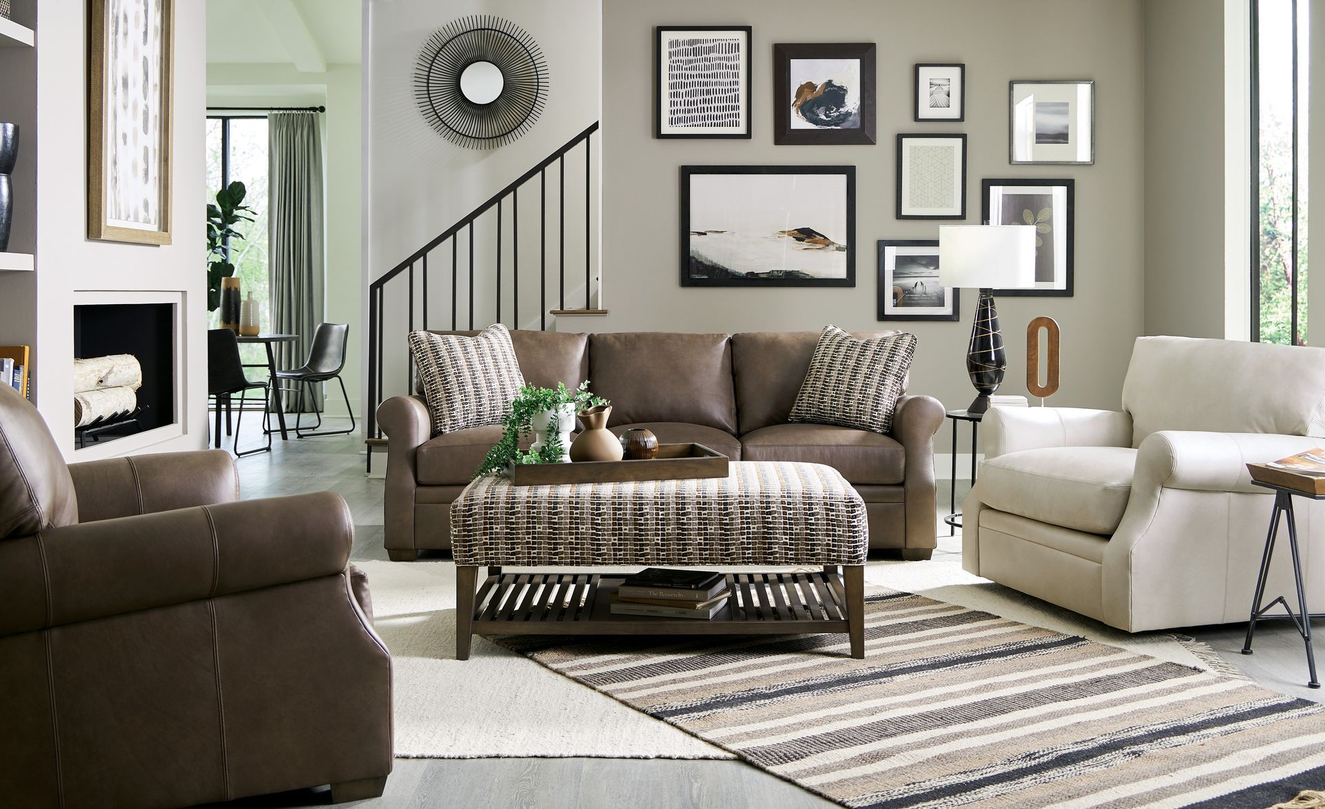 A living room with a couch , chair , coffee table and rug.