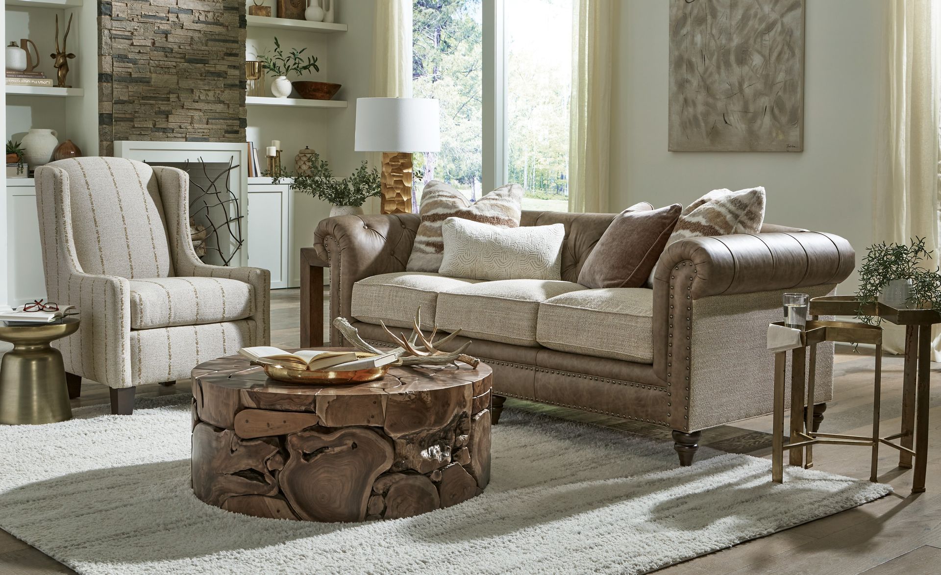A living room with a couch , chair , coffee table and rug.