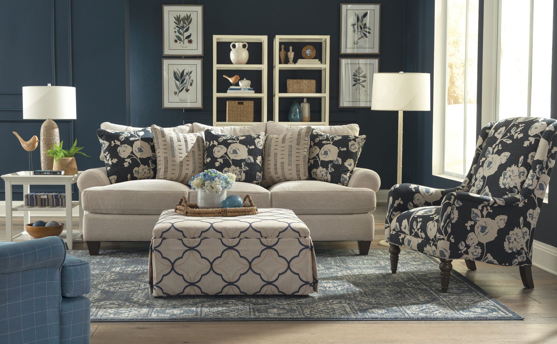 A living room with a couch , chair and ottoman