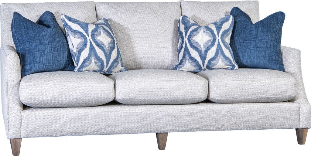 A white couch with blue pillows on it
