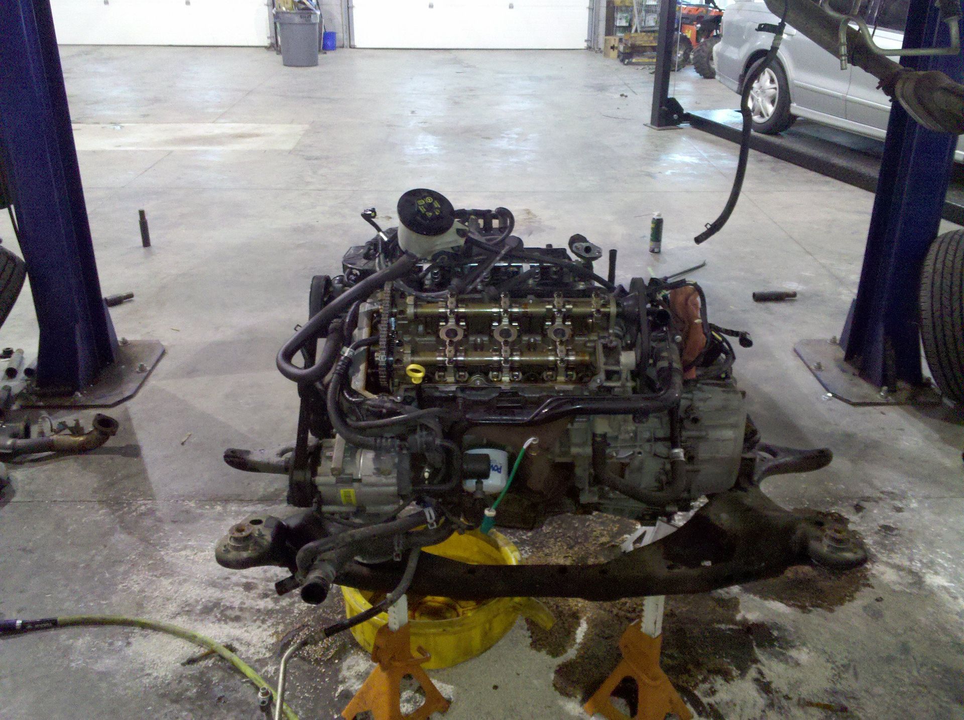 A car engine is being worked on in a garage