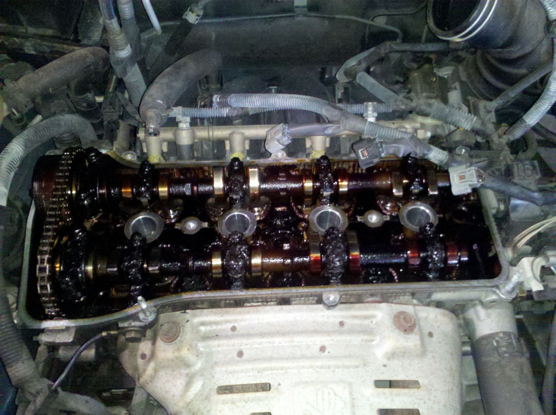 A close up of a car engine with the cylinder head removed