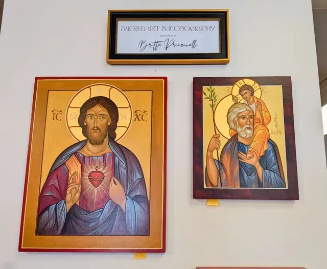 Three framed religious icons on a wall, featuring Christ and the Virgin Mary in warm tones.