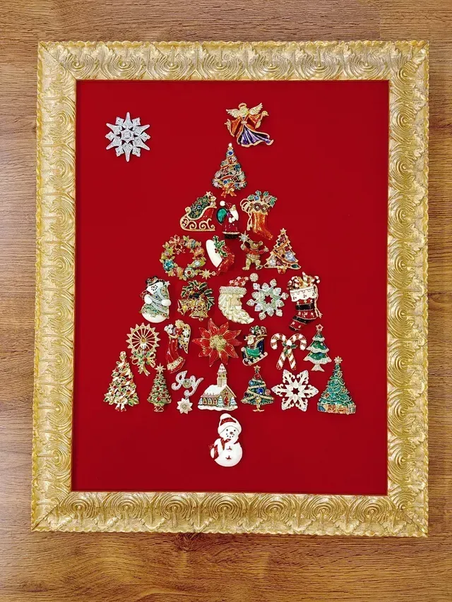 Christmas tree made of ornaments on a red background with a gold frame.