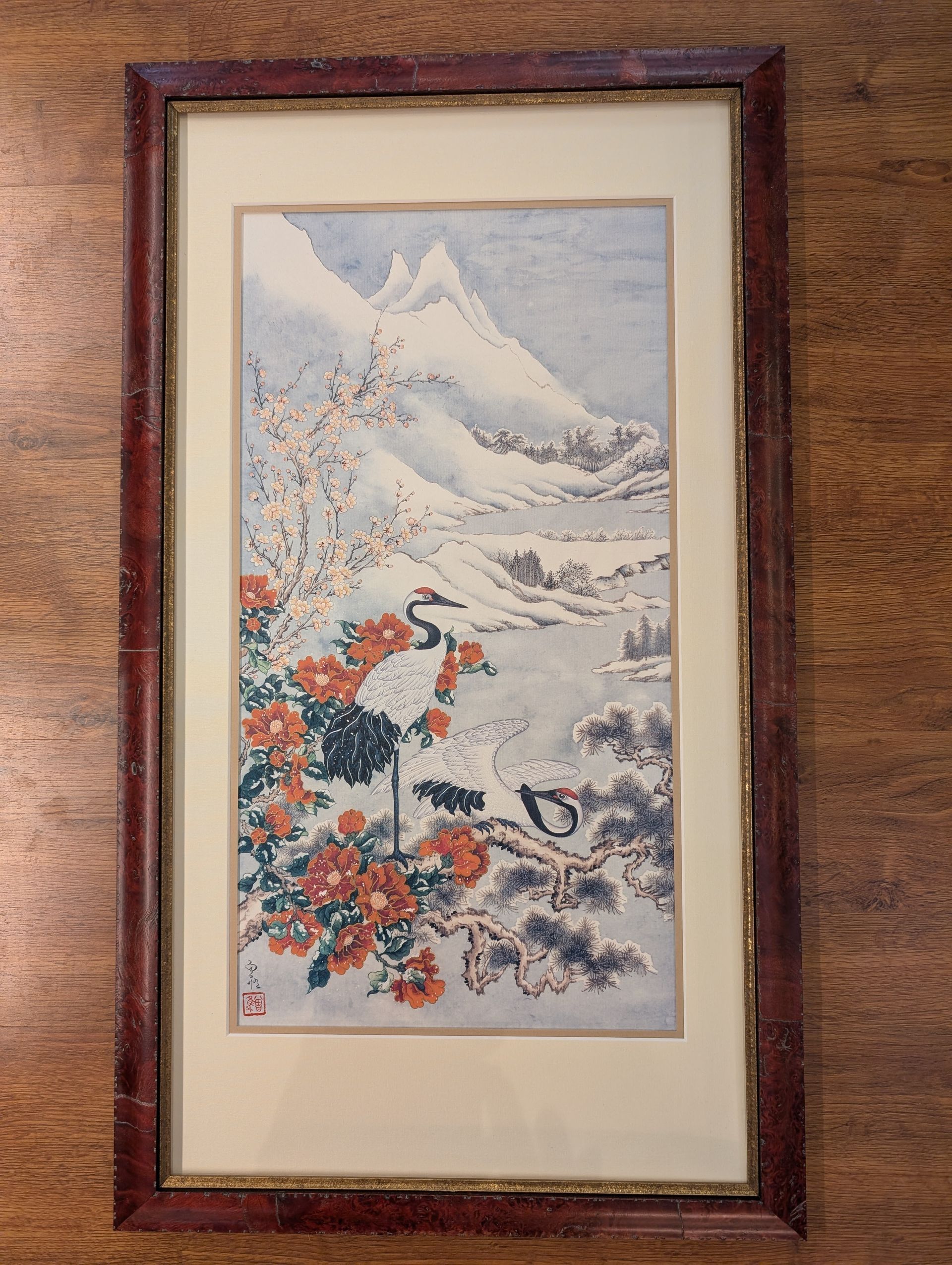 Framed print of Mt. Fuji with red blossoms and a snowy mountain landscape.