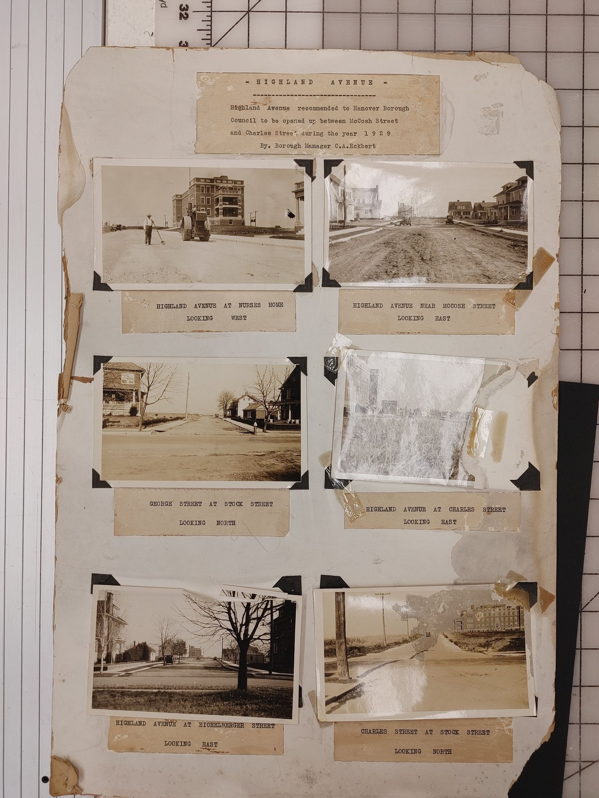 Vintage scrapbook page with six small black-and-white photos and typed captions.