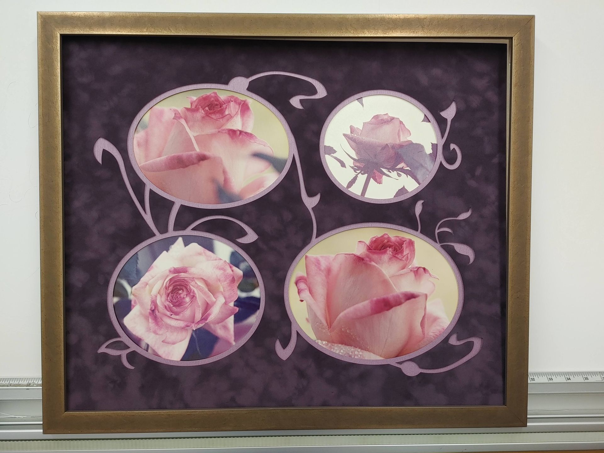 Framed floral collage with four pink rose images on a dark purple background.