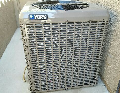 York air conditioning unit outside on a concrete slab.