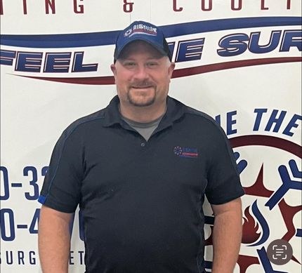A man standing in front of a sign that says feel